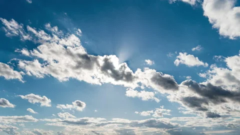 White Fluffy Clouds Slowly Float Through the Blue Daytime Sky Timelapse Stock Footage 218145725