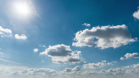 White Fluffy Clouds Slowly Float Through the Blue Daytime Sky Timelapse Stock Footage 218462571