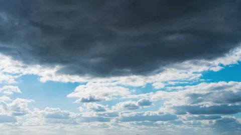 White Fluffy Clouds Slowly Float Through the Blue Daytime Sky Timelapse Stock Footage 229547199