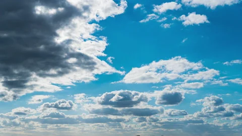 White Fluffy Clouds Slowly Float Through the Blue Daytime Sky Timelapse Stock Footage 229547740