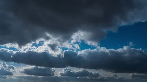 White Fluffy Clouds Slowly Float Through the Blue Daytime Sky Timelapse Stock Footage 236570099
