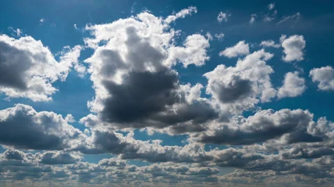 White Fluffy Clouds Slowly Float Through the Blue Daytime Sky Timelapse Stock Footage 237333278