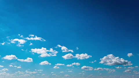 White Fluffy Clouds Slowly Float Through the Blue Daytime Sky Timelapse Stock Footage 237358021