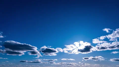 White Fluffy Clouds Slowly Float Through the Blue Daytime Sky Timelapse Stock Footage 237646622