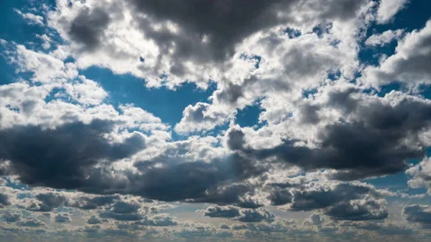 White Fluffy Clouds Slowly Float Through the Blue Daytime Sky Timelapse Stock Footage 237806625