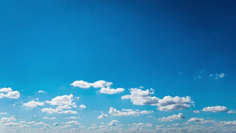 White Fluffy Clouds Slowly Float Through the Blue Daytime Sky Timelapse Stock Footage 237872650