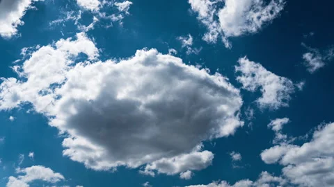 White Fluffy Clouds Slowly Float Through the Blue Daytime Sky Timelapse Stock Footage 241300008