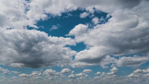 White Fluffy Clouds Slowly Float Through the Blue Daytime Sky Timelapse Stock Footage 243496248