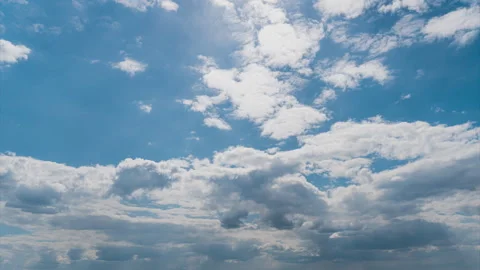 White Fluffy Clouds Slowly Float Through the Blue Daytime Sky Timelapse Stock Footage 243500467