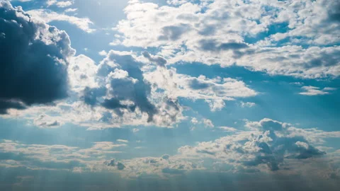 White Fluffy Clouds Slowly Float Through the Blue Daytime Sky Timelapse Stock Footage 243678292