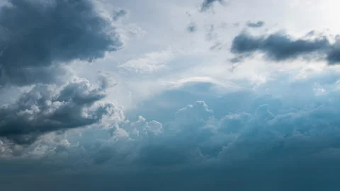 White Fluffy Clouds Slowly Float Through the Blue Daytime Sky Timelapse Stock Footage 243709981