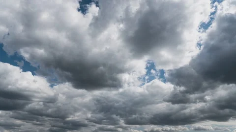White Fluffy Clouds Slowly Float Through the Blue Daytime Sky Timelapse Stock Footage 243715061