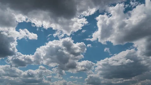 White Fluffy Clouds Slowly Float Through the Blue Daytime Sky Timelapse Video stock 243717811