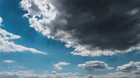 White Fluffy Clouds Slowly Float Through the Blue Daytime Sky Timelapse Stock Footage 243724912