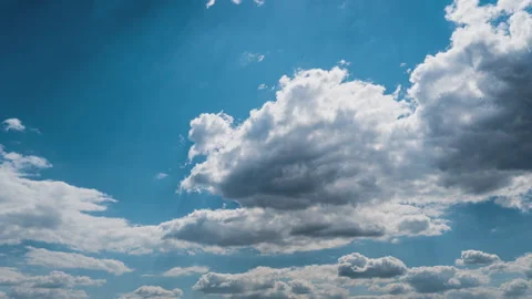 White Fluffy Clouds Slowly Float Through the Blue Daytime Sky Timelapse Stock Footage 243727986