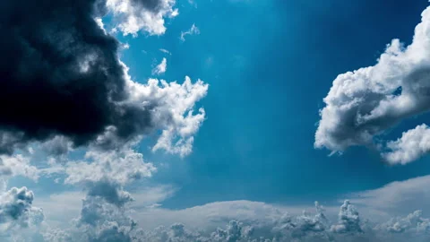 White Fluffy Clouds Slowly Float Through the Blue Daytime Sky Timelapse Stock Footage 243755805