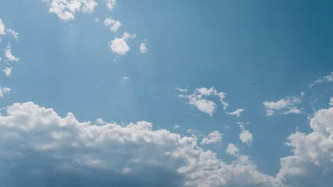 White Fluffy Clouds Slowly Float Through the Blue Daytime Sky Timelapse Stock Footage 244201304