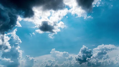 White Fluffy Clouds Slowly Float Through the Blue Daytime Sky Timelapse Stock Footage 244338340