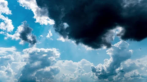 White Fluffy Clouds Slowly Float Through the Blue Daytime Sky Timelapse Stock Footage 244903647