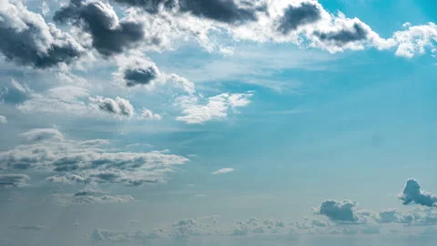 White Fluffy Clouds Slowly Float Through the Blue Daytime Sky Timelapse Stock Footage 244976094