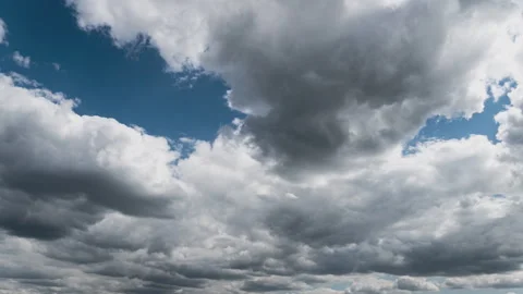 White Fluffy Clouds Slowly Float Through the Blue Daytime Sky Timelapse Stock Footage 245036321