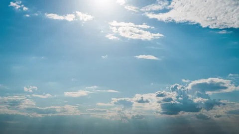 White Fluffy Clouds Slowly Float Through the Blue Daytime Sky Timelapse Stock Footage 245042965