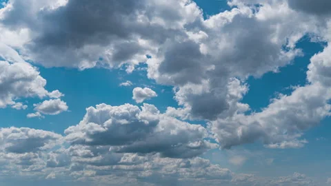 White Fluffy Clouds Slowly Float Through the Blue Daytime Sky Timelapse Stock Footage 246491070