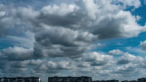 White Fluffy Clouds Slowly Float Through the Blue Daytime Sky Timelapse Stock Footage 252178553
