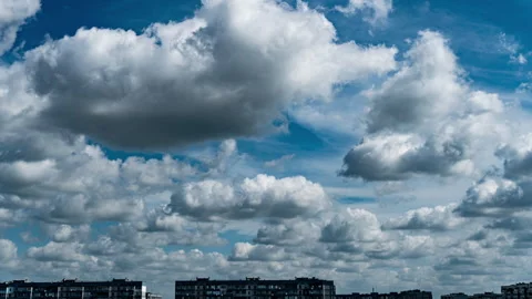 White Fluffy Clouds Slowly Float Through the Blue Daytime Sky Timelapse Stock Footage 252195974