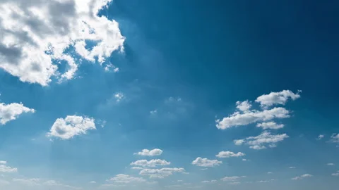 White Fluffy Clouds Slowly Float Through the Blue Daytime Sky Timelapse Stock Footage 252196610