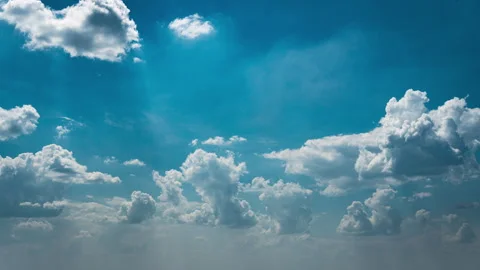 White Fluffy Clouds Slowly Float Through the Blue Daytime Sky Timelapse Stock Footage 252199637