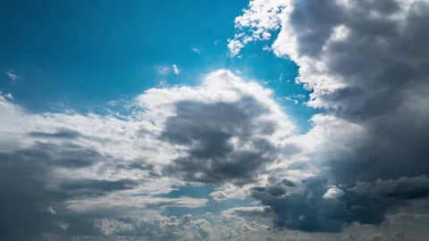 White Fluffy Clouds Slowly Float Through the Blue Daytime Sky Timelapse Stock Footage 252200801