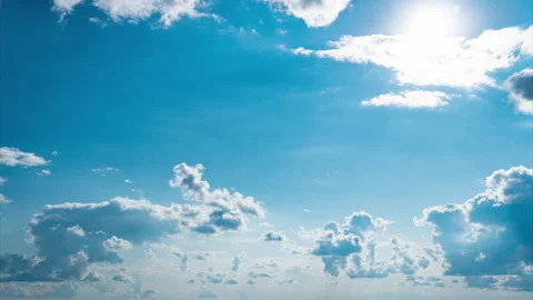White Fluffy Clouds Slowly Float Through the Blue Daytime Sky Timelapse Stock Footage 252201124