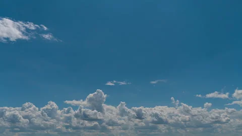 White Fluffy Clouds Slowly Float Through the Blue Daytime Sky Timelapse Stock Footage 252889116