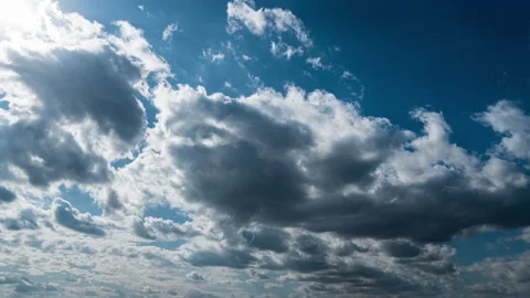 White Fluffy Clouds Slowly Float Through the Blue Daytime Sky Timelapse Video stock 255521434