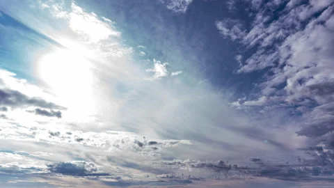 White Fluffy Clouds Slowly Float Through the Blue Daytime Sky Timelapse Video stock 255707663
