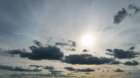 White Fluffy Clouds Slowly Float Through the Blue Daytime Sky Timelapse Stock Footage 256089527