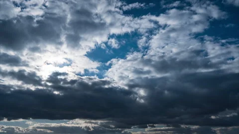 White Fluffy Clouds Slowly Float Through the Blue Daytime Sky Timelapse Stock Footage 263949225