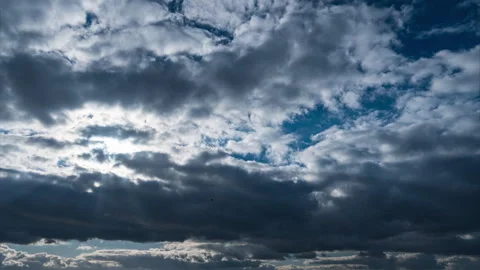 White Fluffy Clouds Slowly Float Through the Blue Daytime Sky Timelapse Stock Footage 264108937