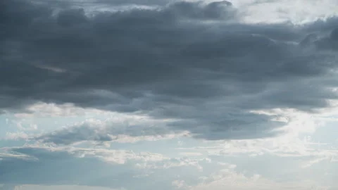 White Fluffy Clouds Slowly Float Through the Blue Daytime Sky Timelapse Video stock 271173763