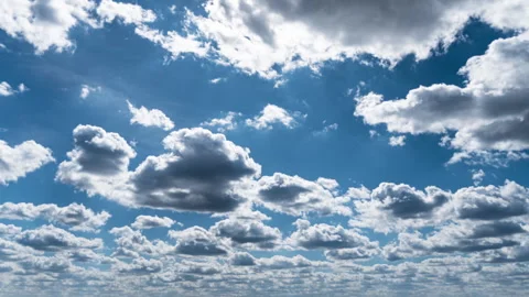 White Fluffy Clouds Slowly Float Through the Blue Daytime Sky Timelapse Stock Footage 271174095