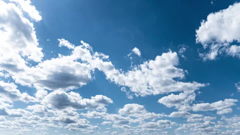 White Fluffy Clouds Slowly Float Through the Blue Daytime Sky Timelapse Stock Footage 271174537