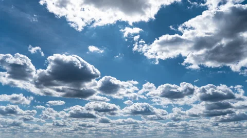 White Fluffy Clouds Slowly Float Through the Blue Daytime Sky Timelapse Stock Footage 271508511