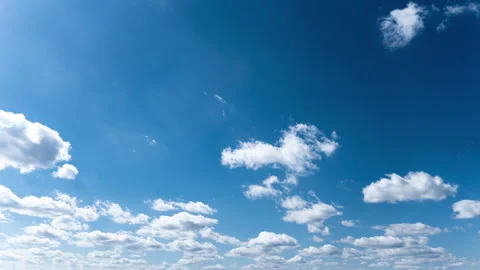 White Fluffy Clouds Slowly Float Through the Blue Daytime Sky Timelapse Stock Footage 271620159