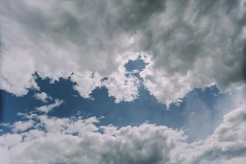 White fluffy clouds with their silver lining Stock Photos