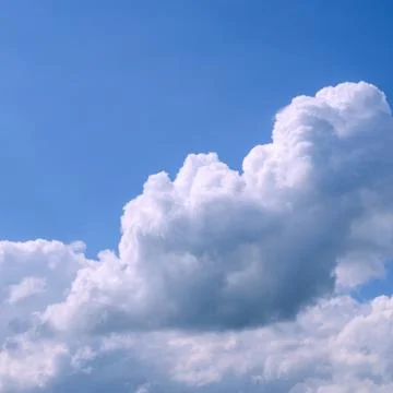 White fluffy clouds in the vast blue sky. Abstract nature background. For ins Stock Photos