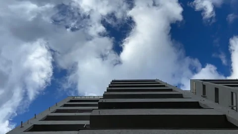 White Fluffy Cumulus Clouds Float by Sky above Building City Time lapse Stock Footage 242424150