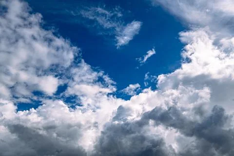 White Fluffy Cumulus Clouds Framing Deep Blue Sky Stock Photos