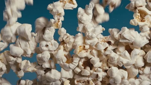 White fluffy pieces of popcorn fall at a slow pace. Stock Footage 105392916
