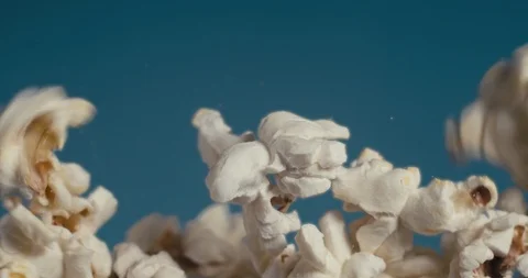 White fluffy pieces of popcorn fall at a slow pace. Stock Footage 105392962